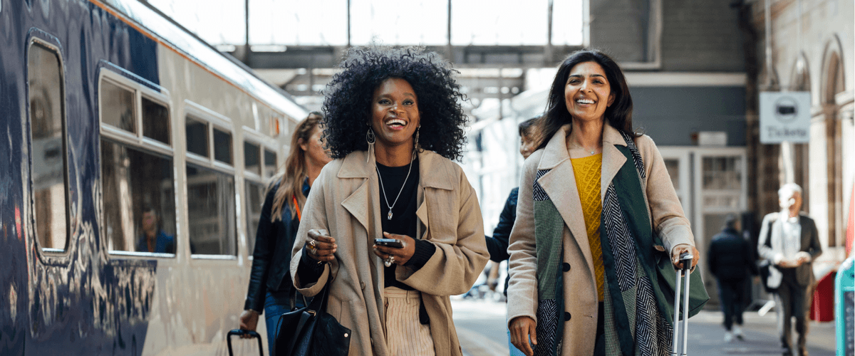two women walking in train station