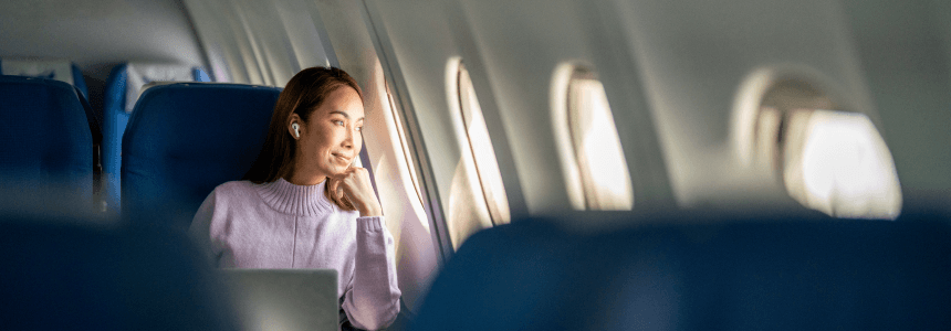 woman sitting on flight looking out the window