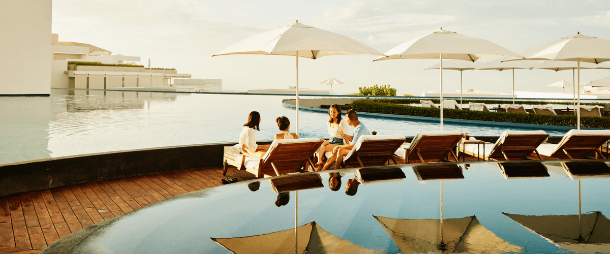 people sitting by an infinity pool